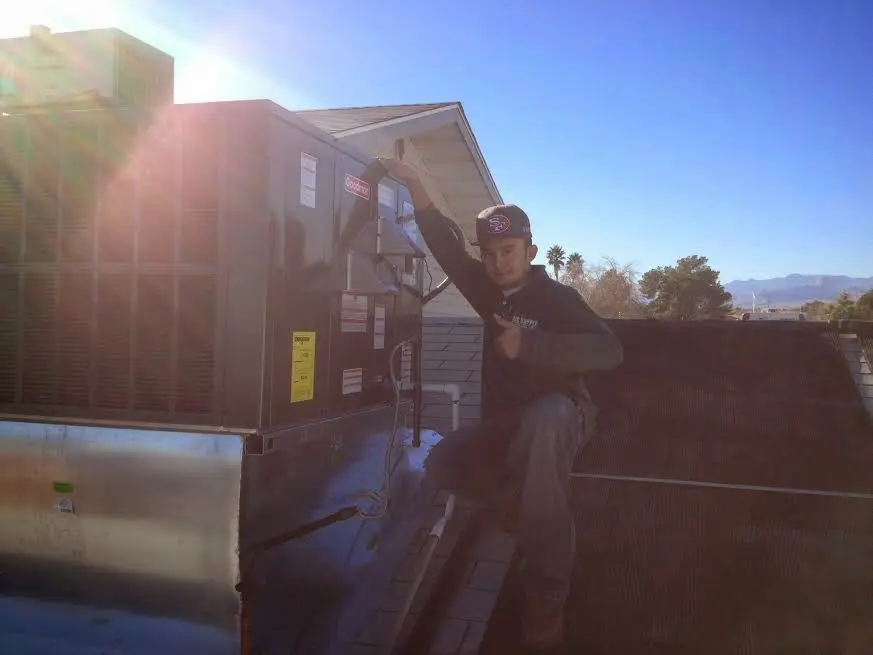 HVAC technician performing Boiler Repair on a rooftop unit in Torrington